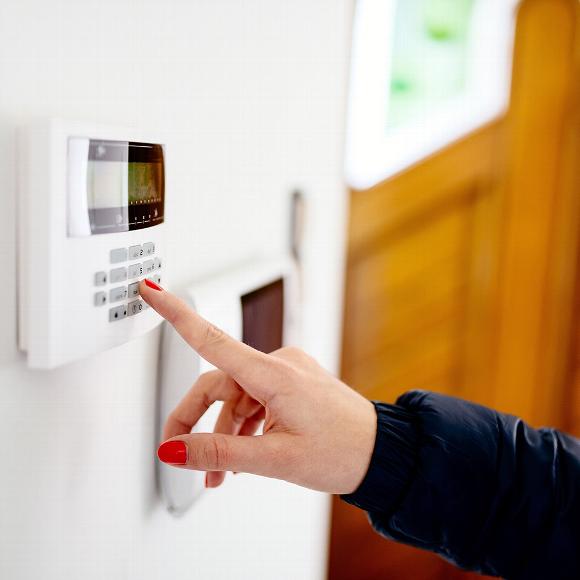 Close up of woman putting in pin number on access control door lock